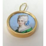 A miniature painted portrait of a lady set in gold.