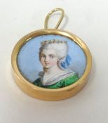 A miniature painted portrait of a lady set in gold.