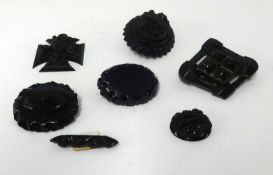 Seven Whitby Jet mourning brooches and pendant.