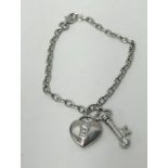 Tiffany, a platinum bracelet, 'Key to My Heart' with diamond set heart and key charms, approx 15.