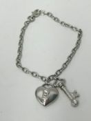 Tiffany, a platinum bracelet, 'Key to My Heart' with diamond set heart and key charms, approx 15.