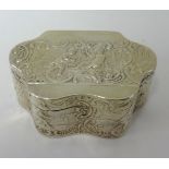 A silver box of wavy edge outline embossed with scrollwork and figures, circa 1895, approx 71.4gms.