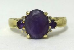 An 18ct gold amethyst 3 stone ring, finger size V1/2.