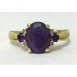 An 18ct gold amethyst 3 stone ring, finger size V1/2.