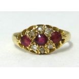 An 18ct gold ruby and diamond fancy cluster ring, finger size L.