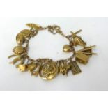 A 9ct gold charm bracelet, approx 27.9gms.