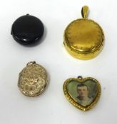 A 9ct gold locket 3.9gms, two other lockets and a pendant.