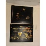 Two Japanese lacquer wall plaques, the first depicting vase, mirror and bird, the second showing two
