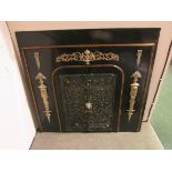 Metal fireplace in dark green enamel with wrought metal hinged gates, the frontage with applied