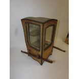 A 19th century table top display cabinet formed as a sedan chair, fabric covered exterior, lined