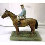 Cold painted cast metal figure of racehorse and jockey mounted on onyx plinth, overall height 16.