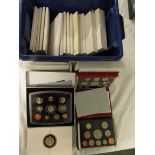 A selection of Royal Mint commemorative crowns in presentation packs and wallets, and ten dollar and