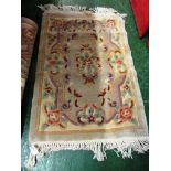 TWO SMALL RECTANGULAR PATTERNED FLOOR RUGS WITH TASSELLED ENDS