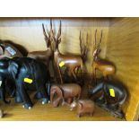 SHELF OF CARVED WOODEN ANIMALS INCLUDING ELEPHANTS