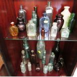 TWO SHELVES OF VINTAGE COMMERCIAL GLASS BOTTLES AND JARS AND ONE STONEWARE BOTTLE