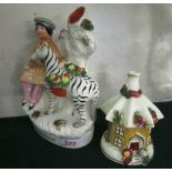 STAFFORDSHIRE POTTERY STYLE SPILL VASE MODELLED WITH SEATED MAN AND ZEBRA (A/F), AND SMALL COTTAGE