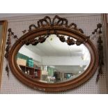 OVAL BEVEL EDGED WALL MIRROR IN MOULDED AND DECORATED GILT FRAME (A/F)