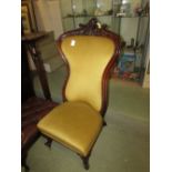 MAHOGANY FRAMED LOW SEATED HIGH BACK CHAIR ON BRASS CASTORS WITH MUSTARD UPHOLSTERED SEAT AND BACK