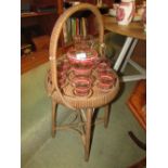 CANE AND RATTAN DRINKS TABLE WITH STRIPED GLASS JUG AND SIX MATCHING GLASSES