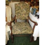 LARGE OAK CARVER CHAIR WITH CARVED SUPPORTS AND FLORAL UPHOLSTERED SEAT AND BACK WITH STUD WORK