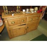 RUSTIC PINE SIDEBOARD WITH TWO DRAWERS OVER TWO CUPBOARD DOORS WITH BRASS SCOOP HANDLES (A/F)