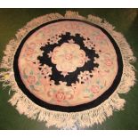 SMALL BLACK GROUND CIRCULAR FLOOR RUG, FLORAL DESIGN AND TASSELLED EDGE (APPROXIMATELY 95CM