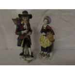 Pair of Chelsea style figures - man in floral coat with shoulder basket of encrusted flowers on a