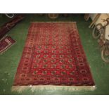 A 20th century Bokhara style pink ground machine made rug of six margins (298cm x 220cm)