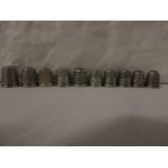 TEN WHITE METAL THIMBLES - stamped sterling, of which five are marked 'The Spa'