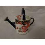 Royal Crown Derby porcelain model of a watering can in the Imari palette, height 7.5cm, red