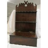 A 19th century oak candle box and spoon rack, flat hinged lid with brass H hinges, wavy fret top,