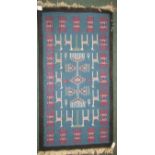 A modern small blue ground rug with black margin and a repeating geometric pattern (112cm x 60cm)