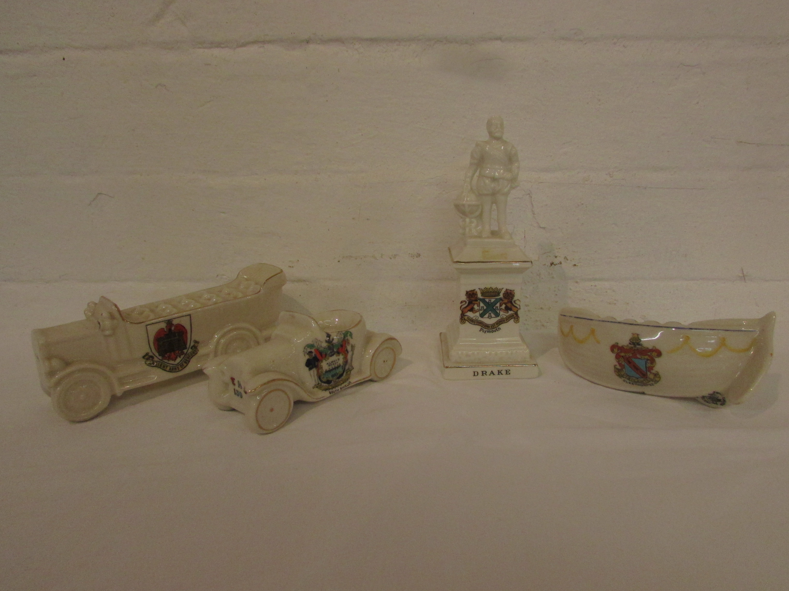 Four items of crested china - a Carlton charabanc 'Over the hills and far way' crested for Ancient