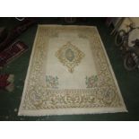 An embossed Indian cream ground rug with central floral feature flanked by a large border of