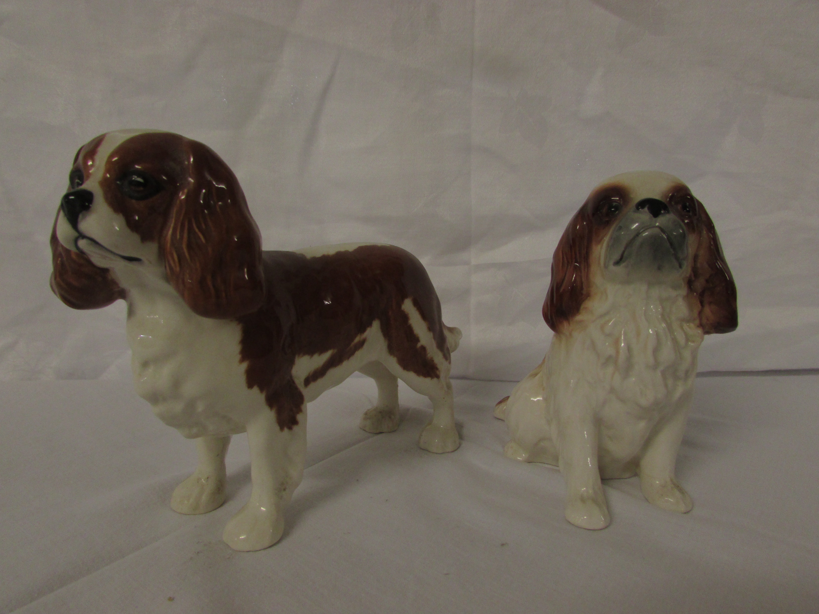 A Beswick model of a standing brown and white spaniel (height 13cm), and a Sylvac model of a