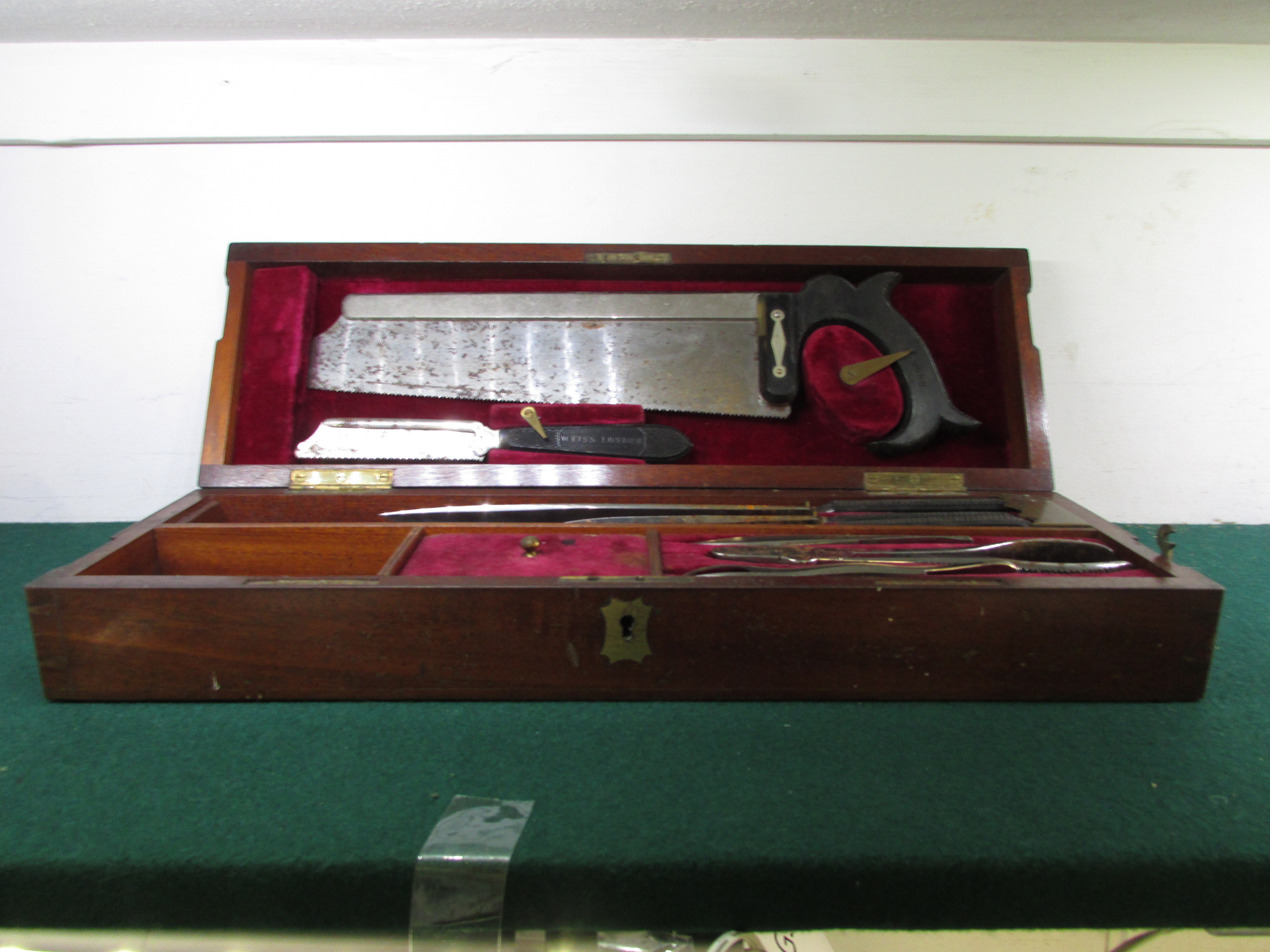 19th century surgical amputation instruments in a mahogany case, two saws and three knives with