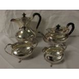 A George V four piece silver tea and coffee set with scalloped rims and paw feet, comprising a tea