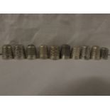 TEN METAL THIMBLES - stamped DORCAS, with various dimpling and foliate patterning