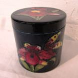 Moorcroft pottery cylindrical lidded jar, blue ground with red and yellow irises, stamped