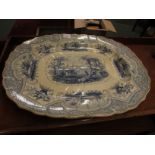 A large pottery meat or turkey plate, 19th century and transfer decorated in blue on white, the base