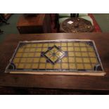 Rectangular leaded and stained glass panel, buff squares with blue trim and central circle and