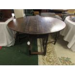 Georgian oak oval gate leg table with single drawer to one end, standing on turned supports,