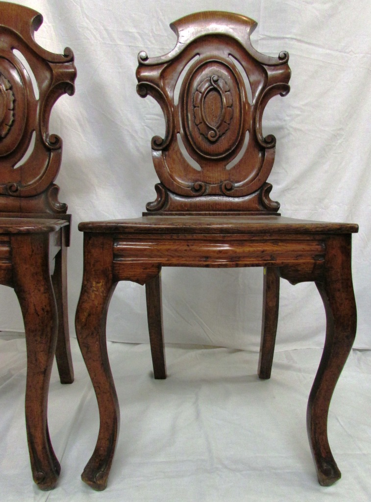 Pair of 19th century oak hall chairs with scrolled and pierced shield shaped backs with stylized - Image 2 of 4