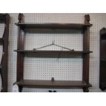 Three-tier wooden wall shelf bracket stained to resemble rosewood, cylindrical supports with acorn