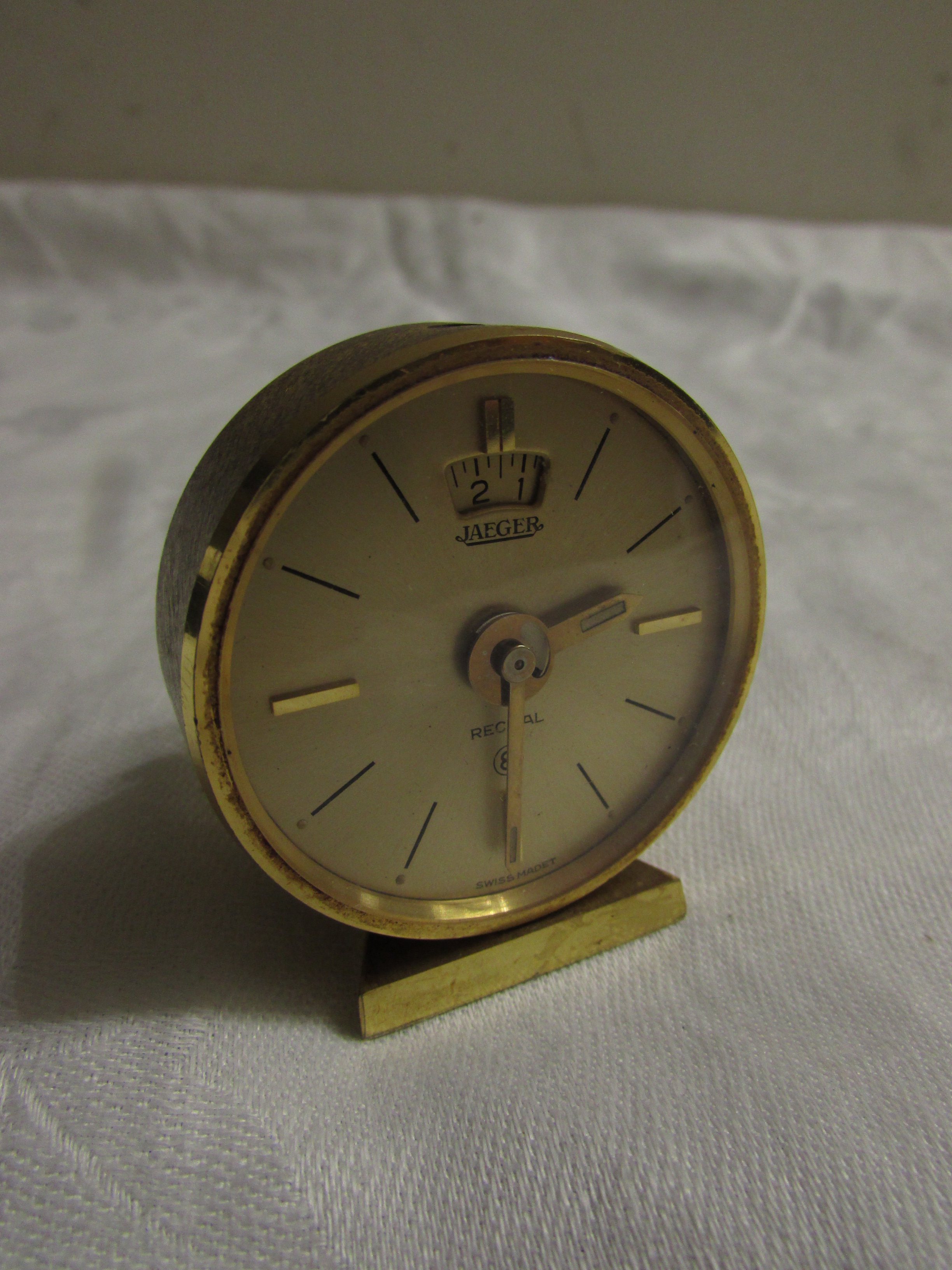 Jaeger Recital eight-day bedside alarm clock in gold coloured finish, diameter of dial 4cm (a/f)