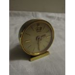 Jaeger Recital eight-day bedside alarm clock in gold coloured finish, diameter of dial 4cm (a/f)