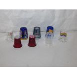 EIGHT GLASS THIMBLES - two red glass with cane work ends, three blue glass, and three clear glass