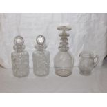 Two heavily cut glass spirit decanters and stoppers, engraved glass milk jug and wine decanter