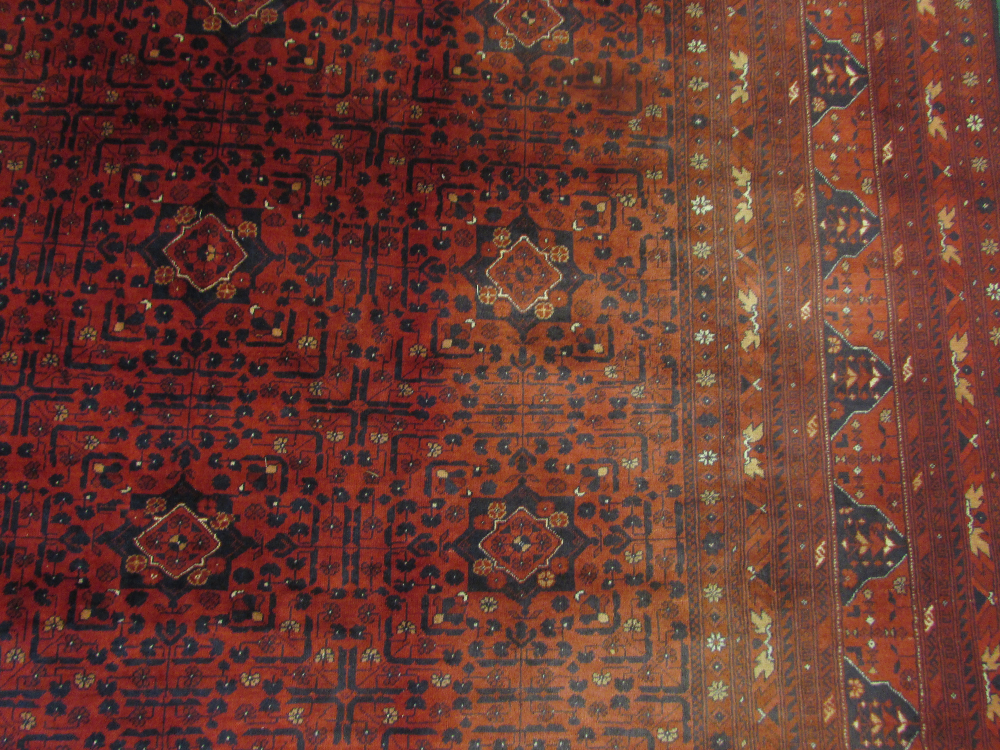 A good quality 20th century Afghan Kunduz red ground machine made rug with twelve small margins, - Image 3 of 3