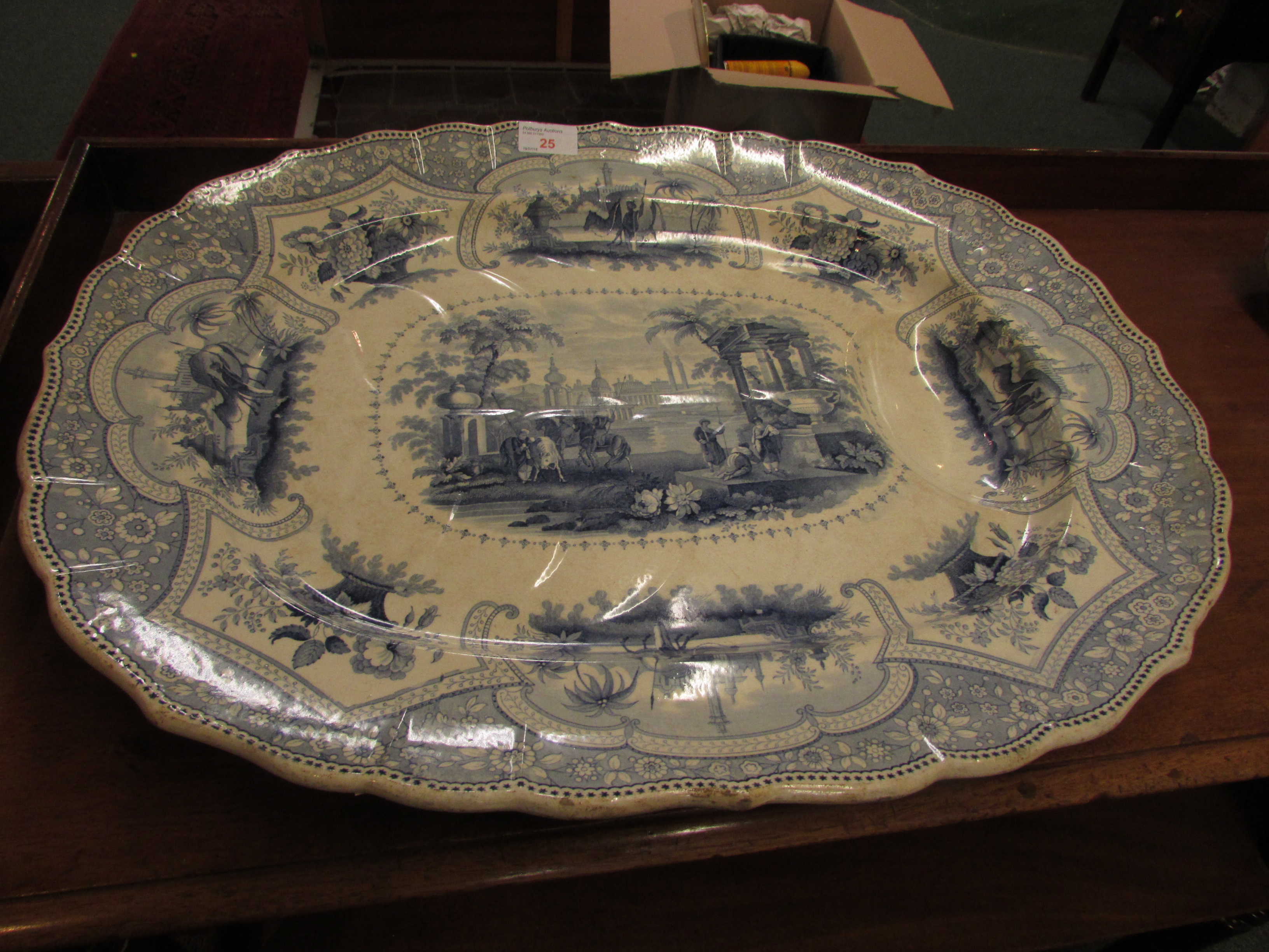 A large pottery meat or turkey plate, 19th century and transfer decorated in blue on white, the base